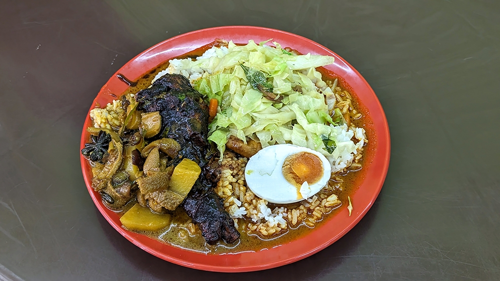 'Nasi kandar' with 'ayam kicap', 'perut', 'kubis' and 'telur masin' with 'kuah campur banjir'. – Pictures by Ethan Lau