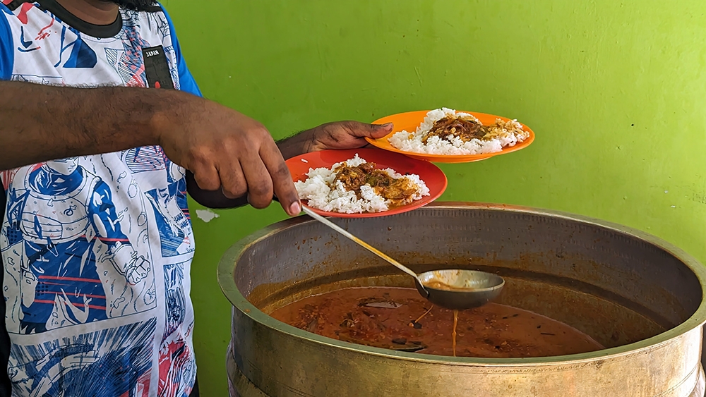 Bilal's colossal cauldron of fish curry is a sight to behold.