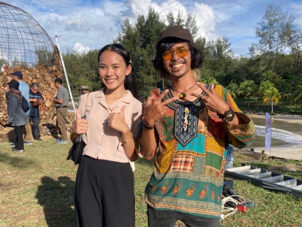 Yaulacap poses with the model of his ‘Motherland’ mural. — Picture courtesy of Yaulacap