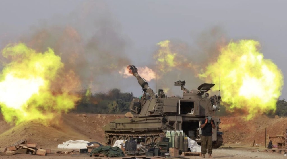 An Israeli army self-propelled artillery howitzer fires rounds from a position near the Gaza border. — AFP pic