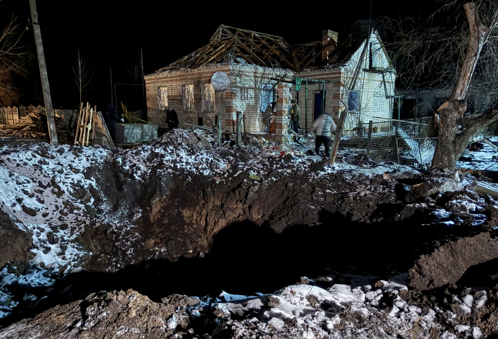 Local residents walk near a house damaged by a Russian missile strike, amid Russia's attack on Ukraine, in the town of Pavlohrad, Dnipropetrovsk region, Ukraine December 8, 2023. ― Reuters pic
