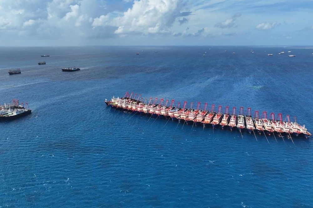 File photo of this handout photo taken on December 2, 2023 and released on December 3 by the Philippine Coast Guard (PCG) showing an aerial view of Chinese vessels gathered by Whitsun Reef, around 320 kilometres west of Palawan Island, in disputed waters of the South China Sea. — AFP pic