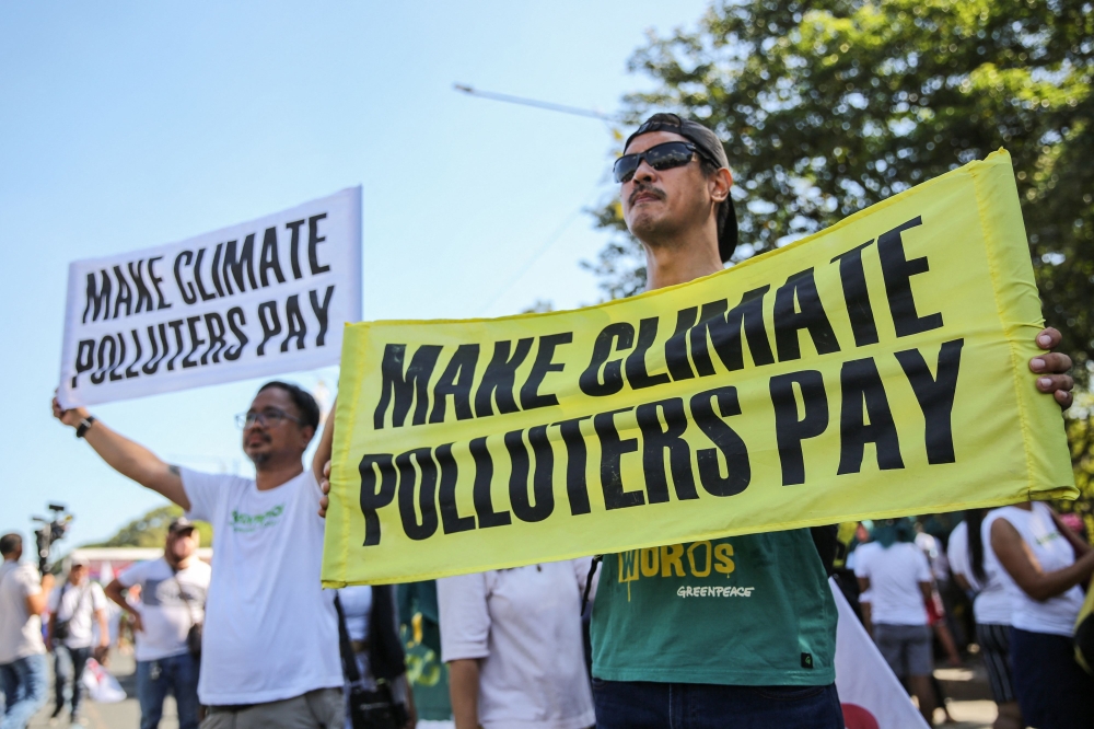 Protesters take part in the Global Day of Action for Climate Justice along Commonwealth Avenue in Quezon City on December 9, 2023, to demand urgent climate action at COP28 United Nations climate summit in Dubai. — AFP pic
