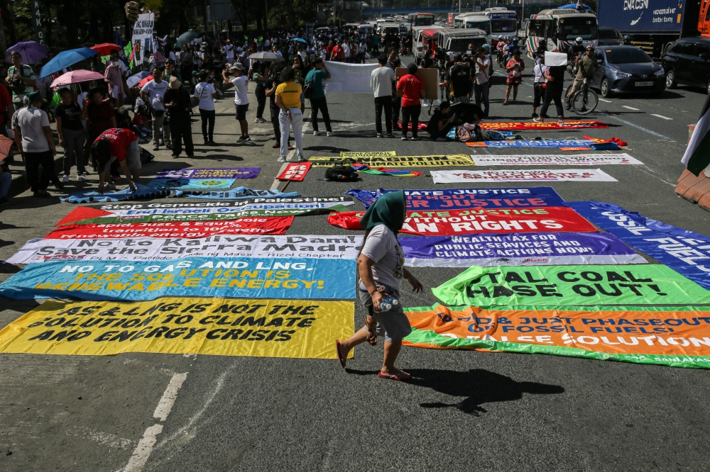 Protesters take part in the Global Day of Action for Climate Justice along Commonwealth Avenue in Quezon City on December 9, 2023, to demand urgent climate action at COP28 United Nations climate summit in Dubai. — AFP pic