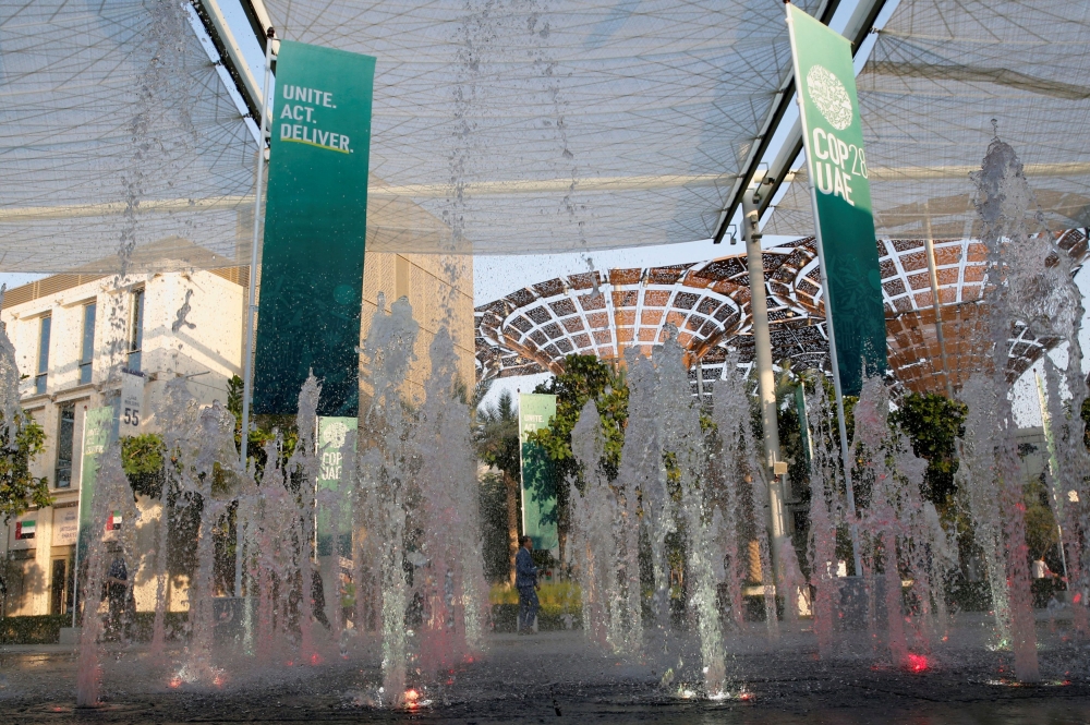 A delegate walks past a water fountain at the Dubai’s Expo City during the United Nations Climate Change Conference (COP28) in Dubai, United Arab Emirates, December 8, 2023. — Reuters pic