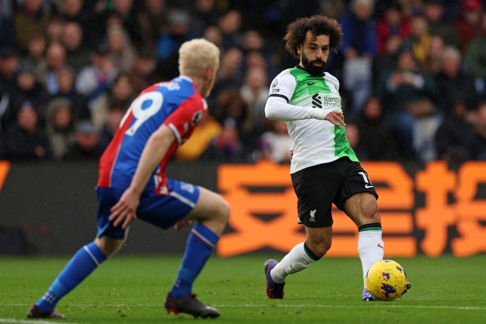 Liverpool’s Egyptian striker #11 Mohamed Salah (right) passes the ball during the English Premier League football match between Crystal Palace and Liverpool at Selhurst Park in south London on December 9, 2023. — AFP pic