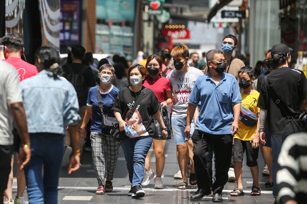People are pictured wearing face masks in Kuala Lumpur April 29, 2023. Dr Kuljit Singh said the simplest way to stop the spike in Covid cases is for people to wear masks in public and to start using sanitisers again. — Picture by Yusof Mat Isa