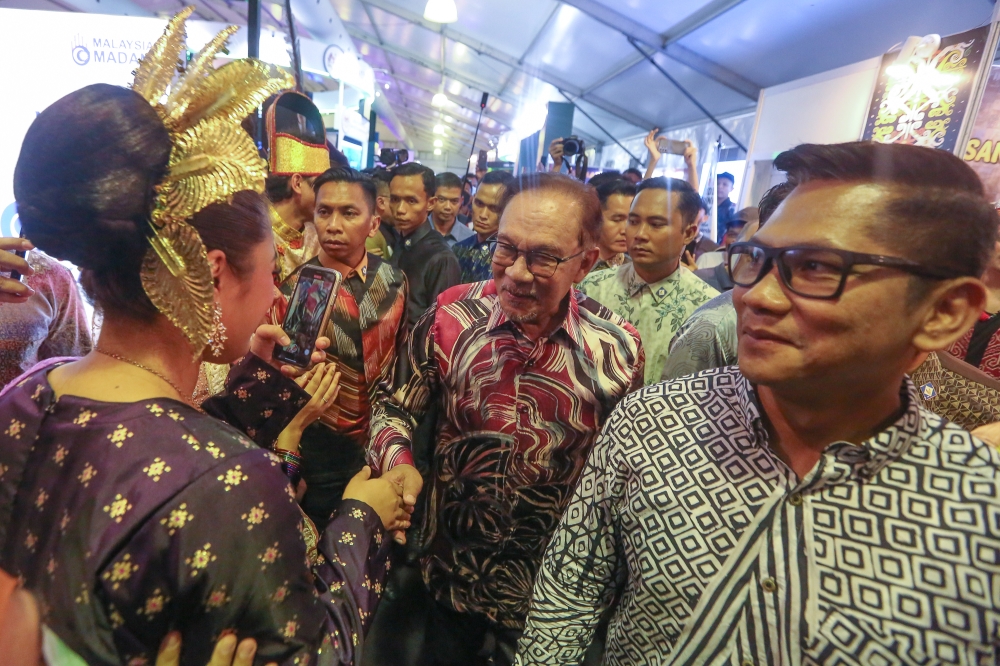 Prime Minister Datuk Seri Anwar Ibrahim visits an exhibition booth during the Madani Government One Year Anniversary Programme at the Bukit Jalil National Stadium December 10, 2023. — Picture by Yusof Mat Isa