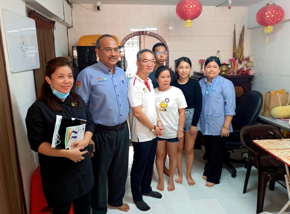 Member of Parliament for the City of Melaka Khoo Poay Tiong (third left) and State Social Security Organization (Socso) Director Abd Razak Omar (second left) presenting Socso Prihatin Squad Benefits to the heirs of insured person at Jalan Gajah Berang Flats, Melaka, December 11, 2023. — Bernama pic