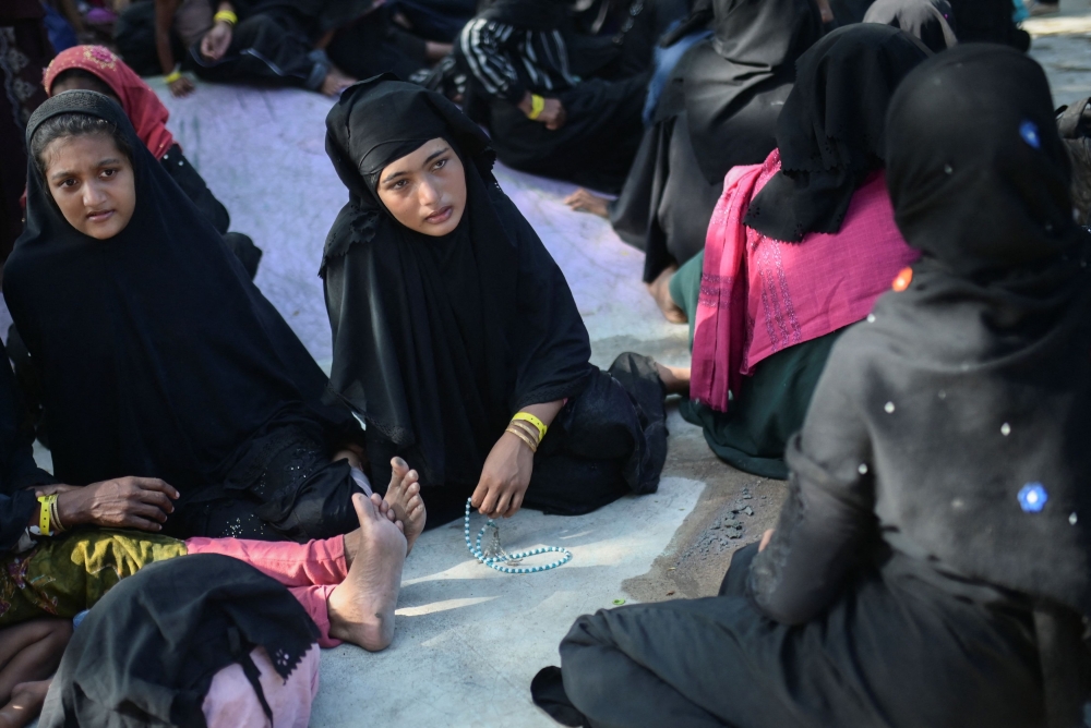 Rohingya Muslim refugee women take rest at a skateboard park that is being used as temporary shelter after they were refused shelter by local residents, following their arrival, in Banda Aceh, Indonesia, December 11, 2023. — Reuters pic