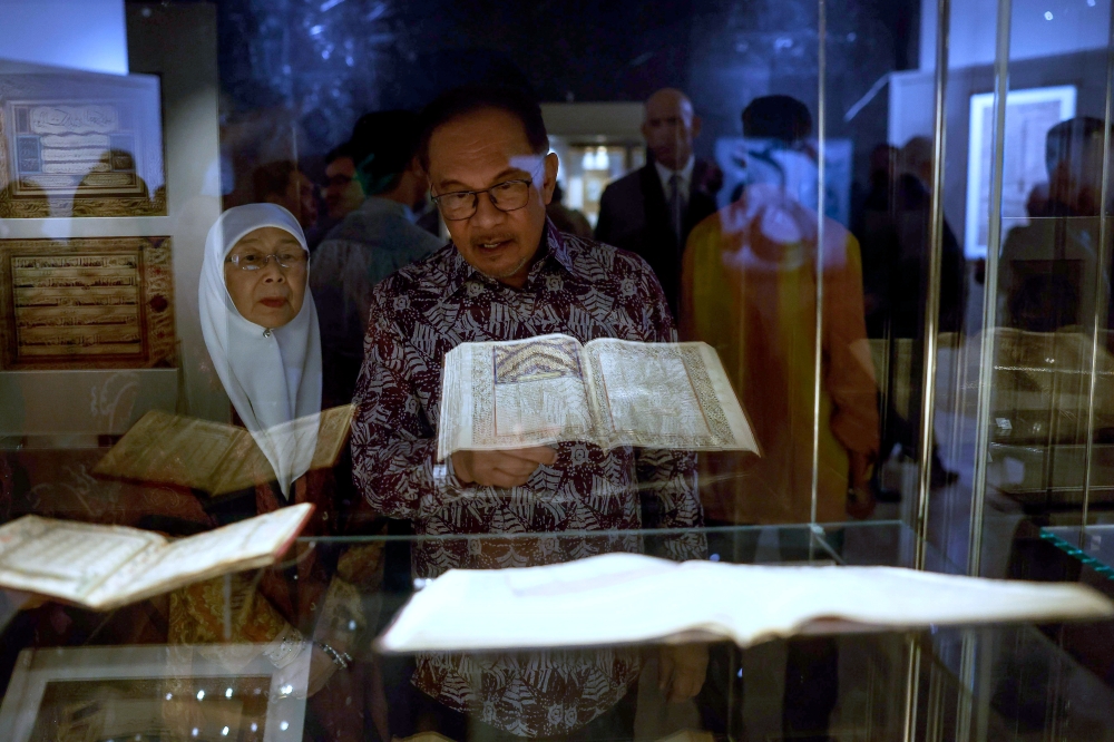 Prime Minister Datuk Seri Anwar Ibrahim and his wife Datuk Seri Dr Wan Azizah Wan Ismail view an exhibit at the Islamic Arts Museum Malaysia, December 12, 2023. — Bernama pic  