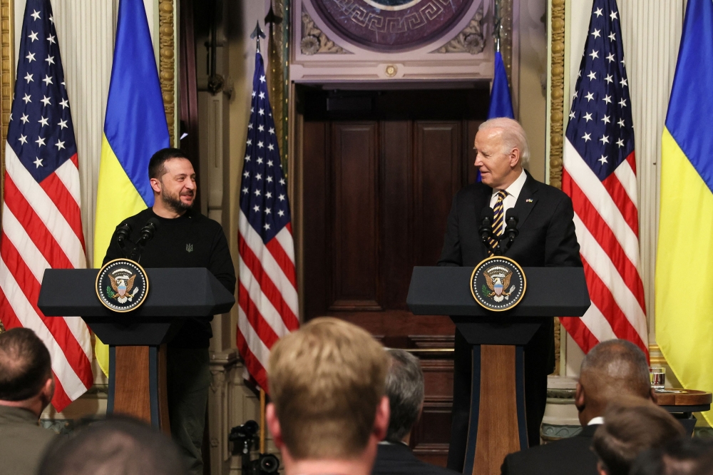 US President Joe Biden and Ukraine’s President Volodymyr Zelensky react during a joint press conference at the White House in Washington December 12, 2023. — Reuters pic