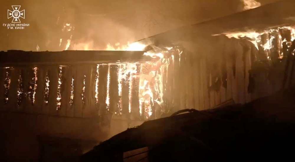 Parts of a building burn after a recent shelling amid Russia's attack on Ukraine, in Kyiv December 13, 2023 in this screengrab taken from a handout video. — State Emergency Service of Ukraine handout pic via Reuters