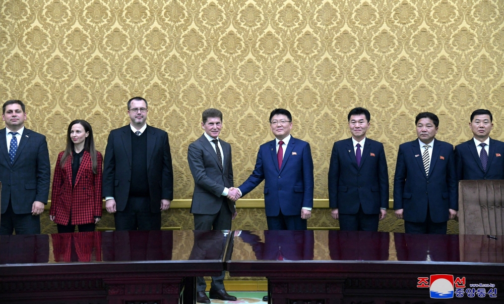 Oleg Kozhemyako, governor of the Russian far eastern region of Primorsky shakes hands with the North Korean External Economic Relations Minister Yun Jong-ho as they meet for talks on economic cooperation, in Pyongyang, in this picture released by the Korean Central News Agency on December 13, 2023. — KCNA handout pic via Reuters