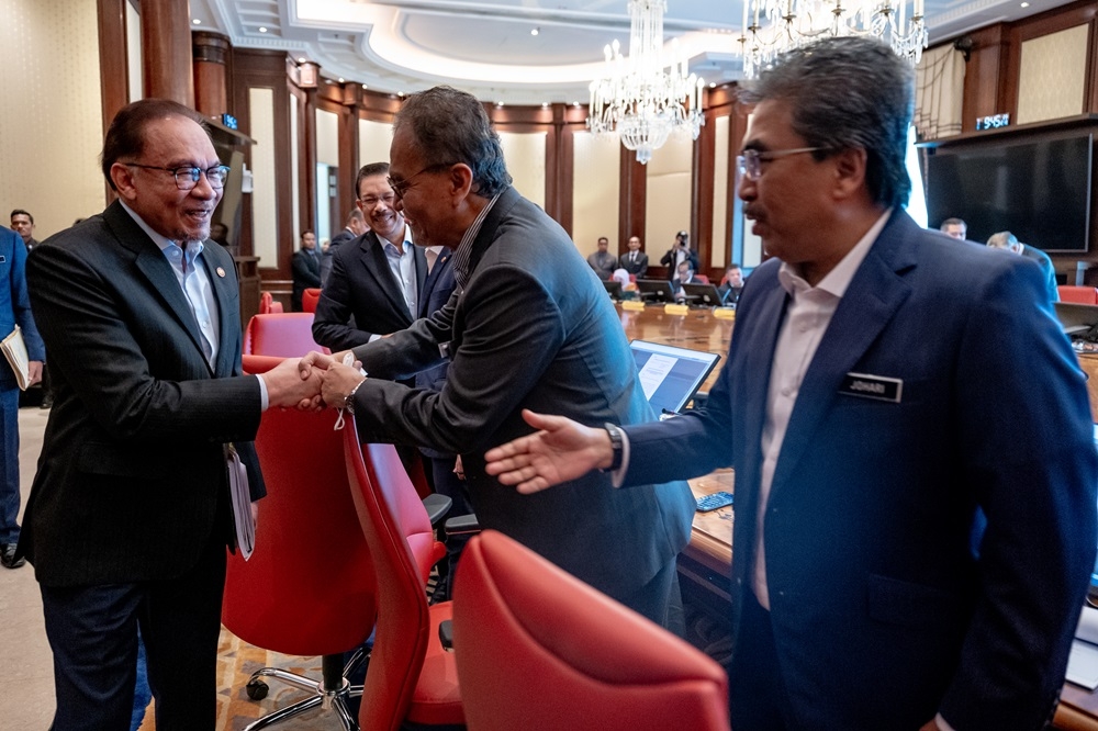 Prime Minister Datuk Seri Anwar Ibrahim greets Minister of Health Datuk Seri Dzulkefly Ahmad and Minister of Agriculture and Commodities Datuk Seri Johari Ghani during the first Cabinet meeting with the new appointments today. — Picture by Afiq Hambali/Prime Minister’s Office of Malaysia
