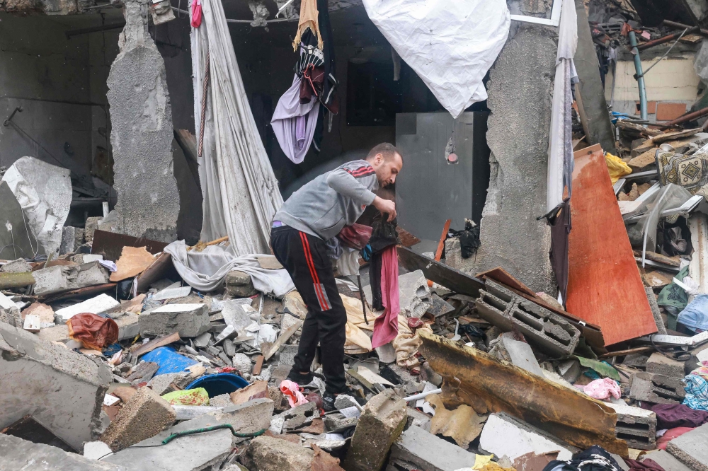 A Palestinian man inspects the damages amid the rubble following Israeli bombardment in Rafah in the southern Gaza Strip on December 13, 2023, as battles continue between Israel and the Palestinian group Hamas. — AFP pic