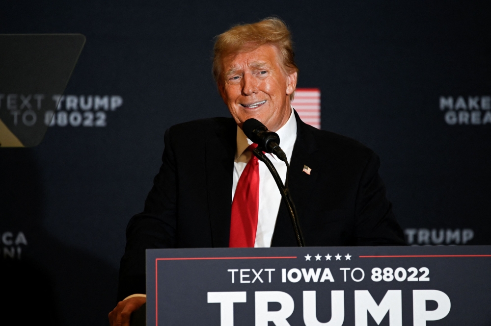 Former US President and Republican presidential candidate Donald Trump speaks during a ‘Commit to Caucus’ event for his supporters in Coralville, Iowa December 13, 2023. — Reuters pic