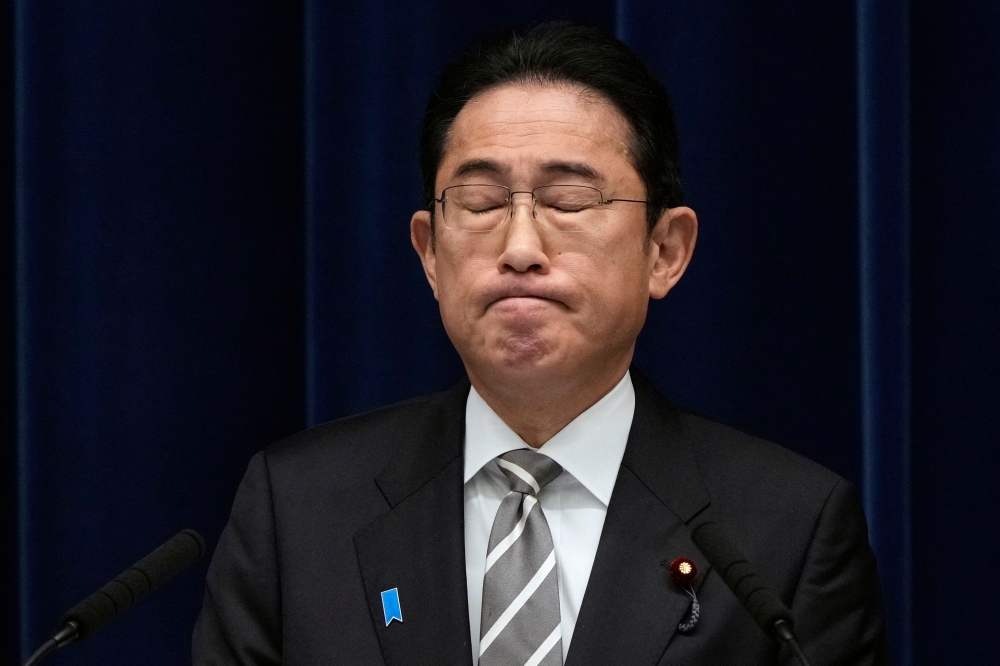 Japanese Prime Minister Fumio Kishida reacts during a news conference at the Prime Minister's Office in Tokyo on December 13, 2023. — Pool pic via AFP
