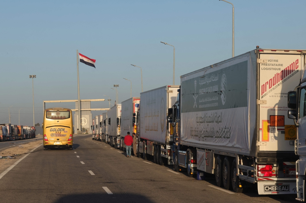 Trucks with humanitarian aid wait to enter the Palestinian side of Rafah on the Egyptian border with the Gaza Strip on December 11, 2023. — AFP pic