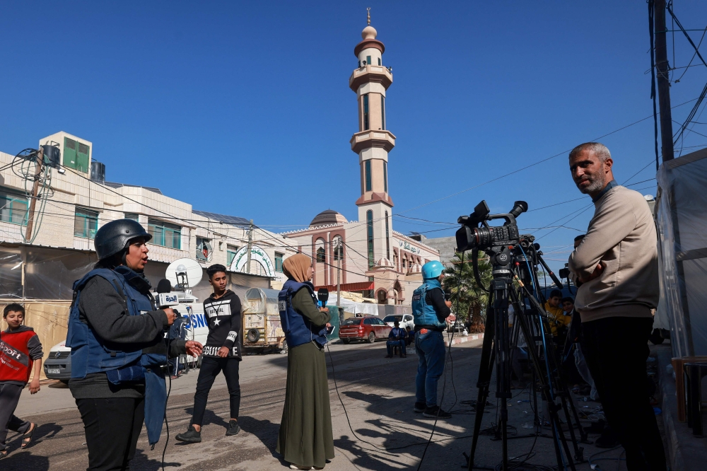 Journalists work on a street in Rafah on the southern Gaza Strip on December 11, 2023, amid continuing battles between Israel and Hamas. — AFP pic