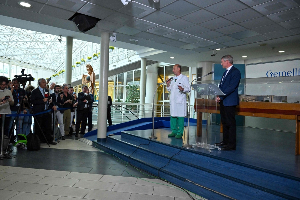 Director of the department of Abdominal and Endocrine Metabolic Medical and Surgical Sciences at the Gemelli hospital, professor Sergio Alfieri (centre) and Director of the Holy See Press Office, Matteo Bruni (right) speak to the media on June 7, 2023 at the Gemelli hospital in Rome. Alfieri is accused of having falsely declared to have been the operating surgeon ‘in many cases’, while being somewhere else entirely, according to Italy’s La Stampa daily, which alleged it was a scam to pocket extra private sector fees. — AFP pic