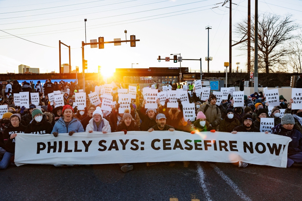 Protesters from the national group Jewish Voice for Peace call for a ceasefire in the Israel-Hamas war during rallies across the U.S. marking the 8th night of Hanukkah as they block a highway in Philadelphia, Pennsylvania December 14, 2023. — Reuters pic