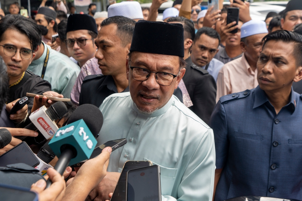 Prime Minister Datuk Seri Anwar Ibrahim speaks to reporters after performing Friday prayers at Surau Al-Kauthar in Bangi December 15, 2023. — Picture by Shafwan Zaidon