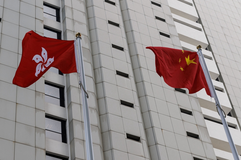 Chinese and Hong Kong flags are seen outside the High Court in Hong Kong. China lashed out at Britain and the United States today after they condemned Hong Kong police for offering bounties for information leading to the capture of five overseas activists. — Reuters pic  