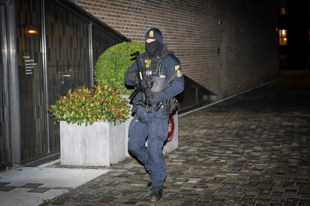 A Danish police officer stands guard in front of the court in Frederiksberg, Copenhagen, Denmark, for the constitutional hearing on December 14, 2023. Danish authorities said on December 14, 2023 they prevented a terror attack after three arrests in Denmark and a fourth in the Netherlands, as Israel said the suspects in Denmark were acting ‘on behalf of Hamas’. — Emil Nicolai Helms/Ritzau Scanpix/AFP pic