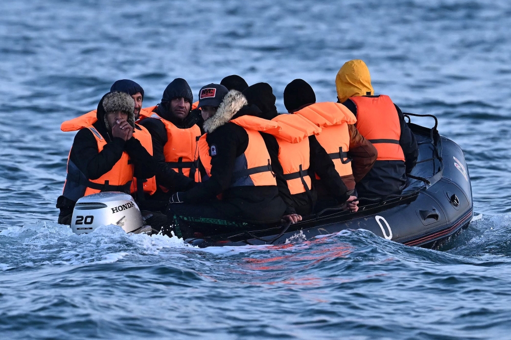 Migrants travel in an inflatable boat across the English Channel, bound for Dover on the south coast of England. — AFP pic