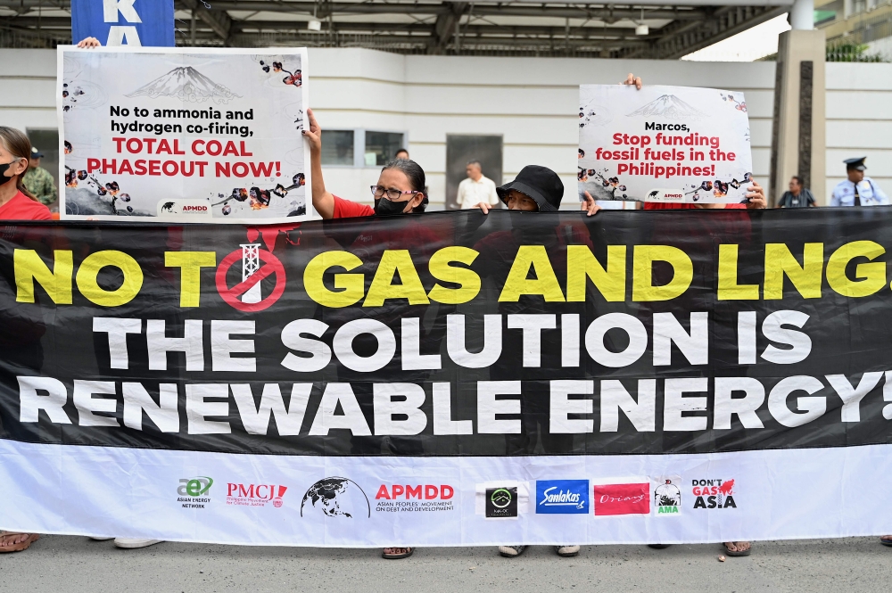 Protesters demonstrate outside the Embassy of Japan in Manila December 15, 2023, on the eve of the Commemorative Summit of the 50th Asean-Japan Friendship and Cooperation. — AFP pic