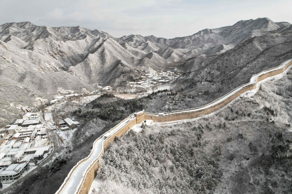 This photo shows an aerial view of a snow-covered section of the Great Wall of China at Shuiguan, north of Beijing, after an overnight snowfall December 15, 2023. — AFP