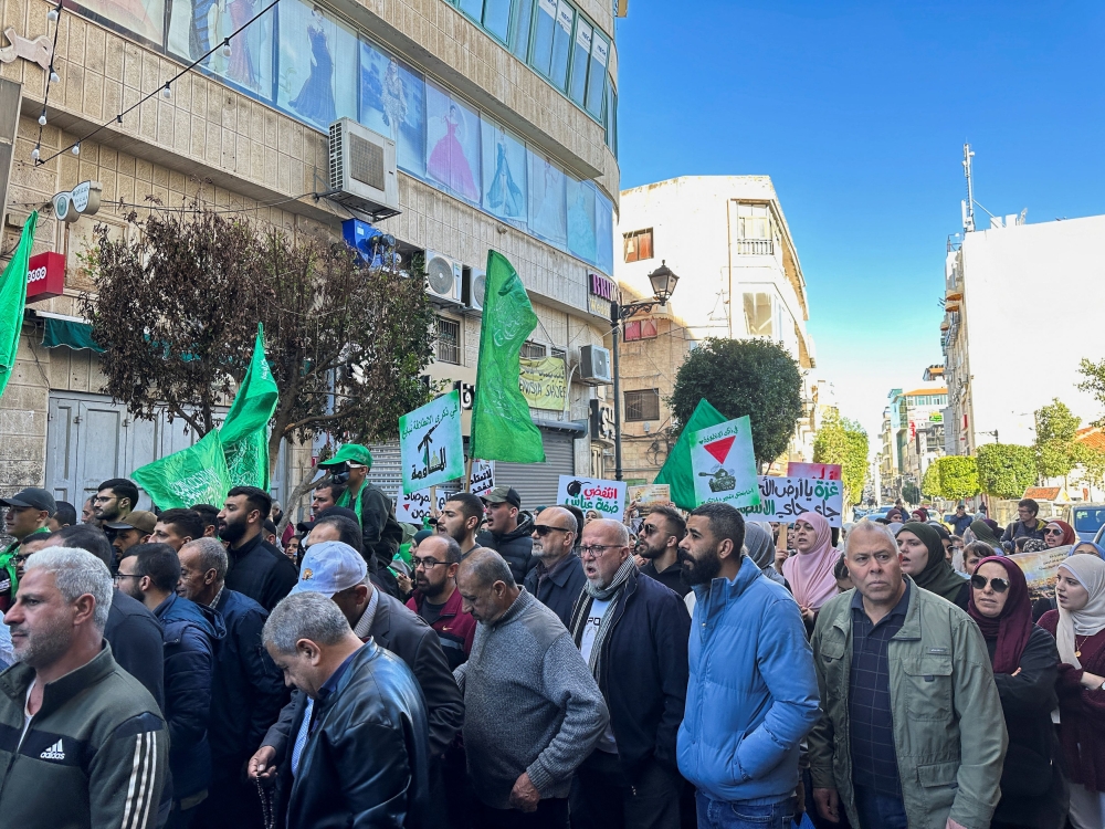 People march as they take part in a protest in support of Palestinians in Gaza, amid the ongoing conflict between Israel and the Palestinian Islamist group Hamas, in Ramallah, in the Israeli-occupied West Bank, December 15, 2023. — Reuters pic