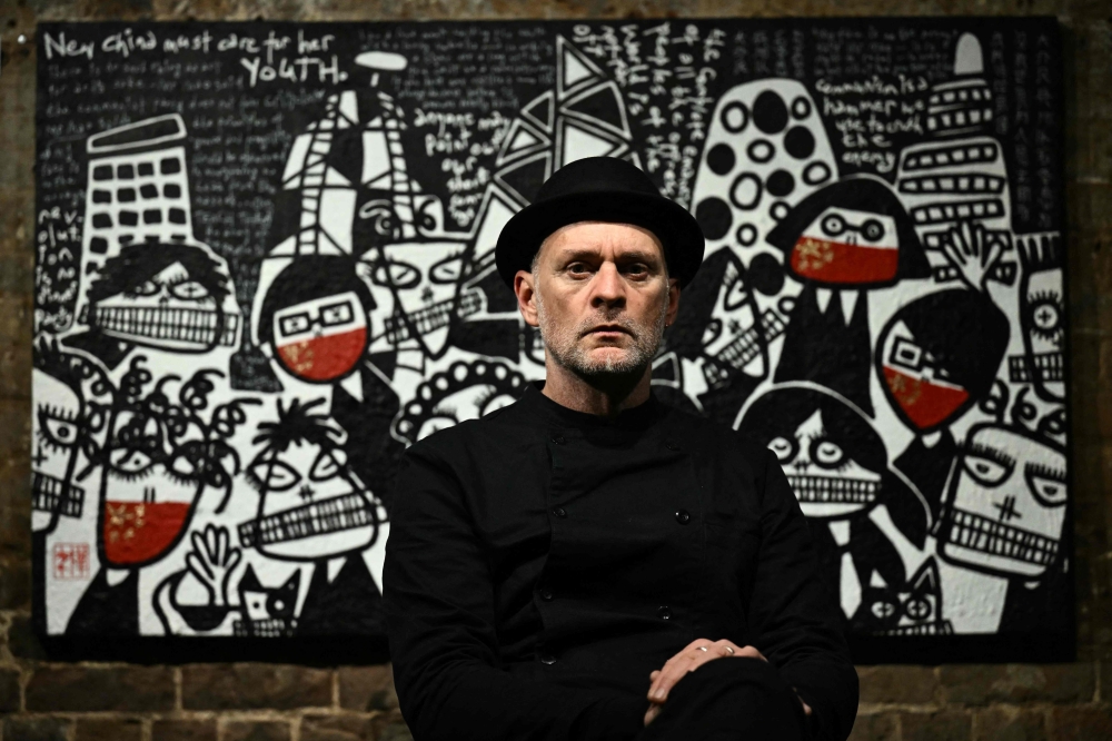 Artist Martin Lever poses for a portrait in front of ‘All Quiet at the Banks’ ahead of the opening of the ‘SILENT PROTEST’ (The Day Hong Kong Lost its Voice)’ exhibition at the Crypt Gallery in London on December 15, 2023. — AFP pic