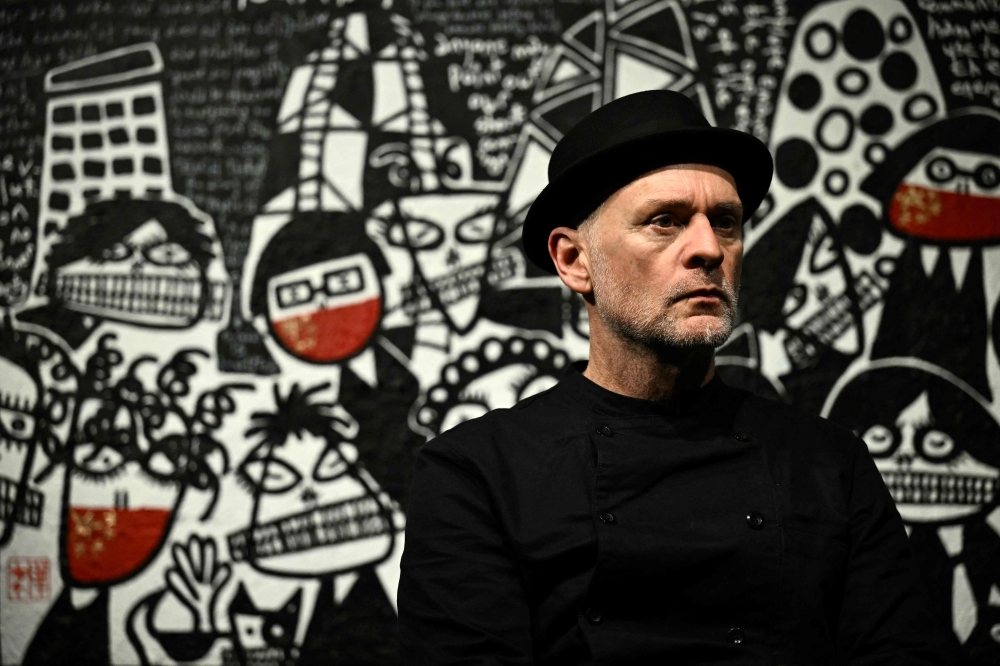 Artist Martin Lever poses for a portrait in front of ‘All Quiet at the Banks’ ahead of the opening of the ‘SILENT PROTEST’ (The Day Hong Kong Lost its Voice)’ exhibition at the Crypt Gallery in London on December 15, 2023. — AFP pic