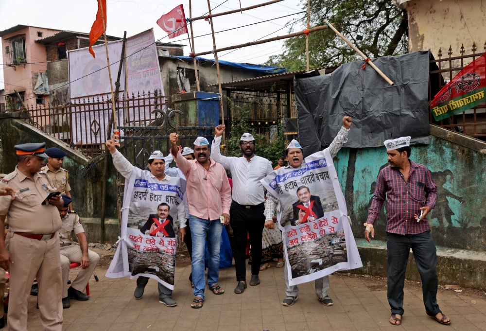 File photo of people shouting slogans as they wear banners during a protest against the redevelopment of Dharavi, one of Asia’s largest slums, by the Adani Group in Mumbai, India, August 9, 2023. — Reuters pic