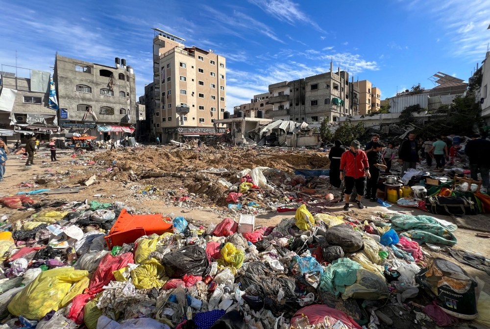 Palestinians inspect damages following an Israeli raid at Kamal Adwan hospital, amid the ongoing conflict between Israel and Palestinian Islamist group Hamas, in the northern Gaza Strip December 16, 2023. — Reuters pic