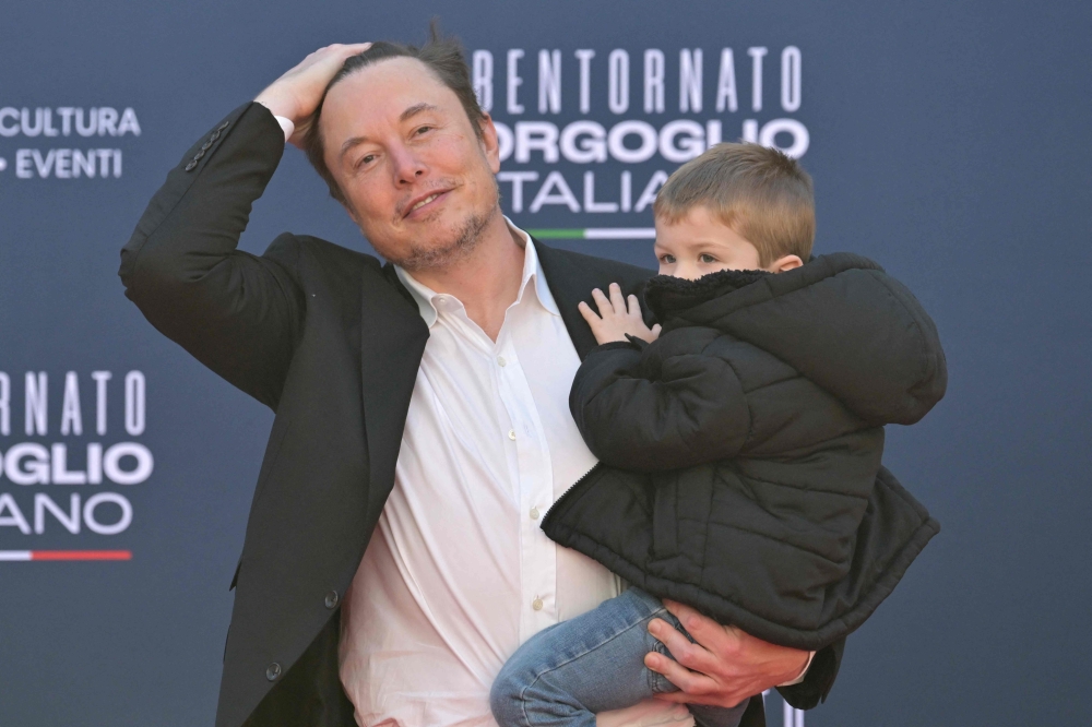 X (formerly Twitter) CEO Elon Musk holds his son as he arrives at the Atreju political meeting organised by the young militants of Italian right wing party Brothers of Italy (Fratelli d’Italia) on December 16, 2023 at the Sant’Angelo Castle in Rome. — AFP pic