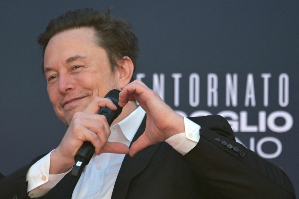 X (formerly Twitter) CEO Elon Musk makes a heart with his hands during the Atreju political meeting organised by the young militants of Italian right wing party Brothers of Italy (Fratelli d'Italia) on December 16, 2023 at the Sant’Angelo Castle in Rome. — AFP pic