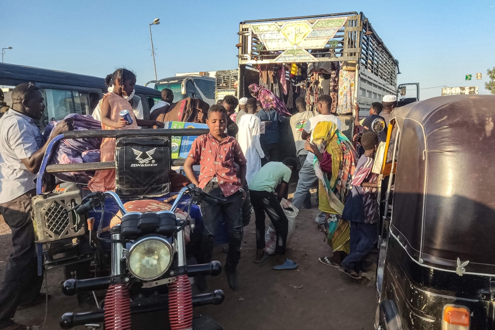 People displaced by the conflict in Sudan get in their transporation as they flee Wad Madani, the capital of al-Jazirah state, heading to Gadaref state on December 16, 2023. Fighting between the Sudanese army and paramilitaries engulfed the aid hub of Wad Madani on December 15, triggering an exodus of civilians already displaced by eight months of war, an AFP correspondent reported. — AFP pic