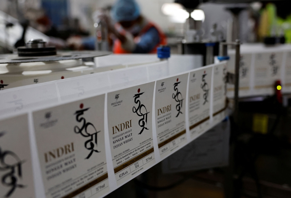 Indian single malt whisky Indri package tags move on a conveyer belt inside Piccadily Distilleries, in Indri, in the northern state of Haryana, India, December 14, 2023. — Reuters pic  