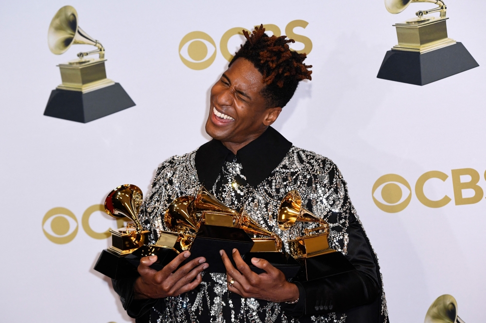 US singer Jon Batiste poses in the press room with his Grammys during the 64th Annual Grammy Awards at the MGM Grand Garden Arena in Las Vegas on April 3, 2022. — AFP pic