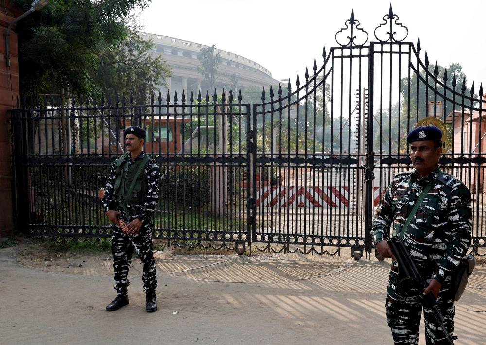 Security force personnel stand guard outside the parliament premises after a man jumped into the lawmakers' area of the lower house of India's parliament, in New Delhi December 13, 2023. 