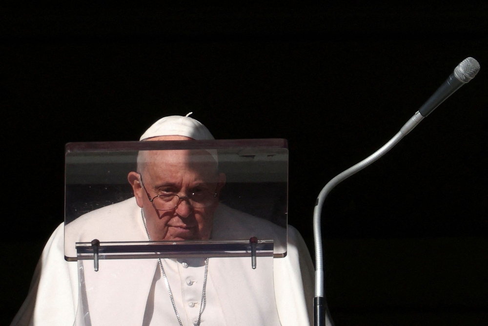 Pope Francis looks on to lead the Angelus prayer from his window, at the Vatican, December 17, 2023.  — Reuters pic