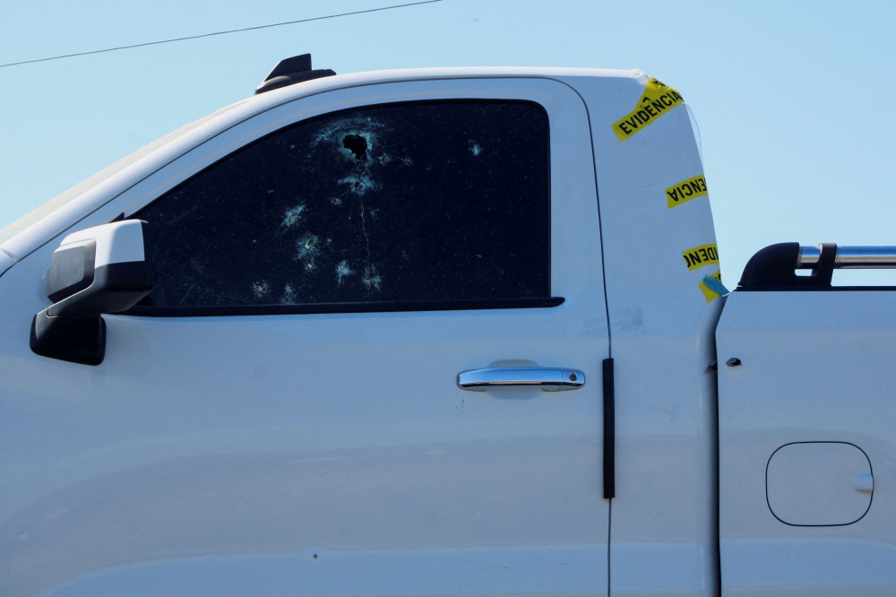 A bullet-riddled truck is transported on a tow truck off the scene where members of an armed group opened fire to partygoers attending a posada, in Salvatierra, in Guanajuato state, Mexico, December 17, 2023. — Reuters pic  