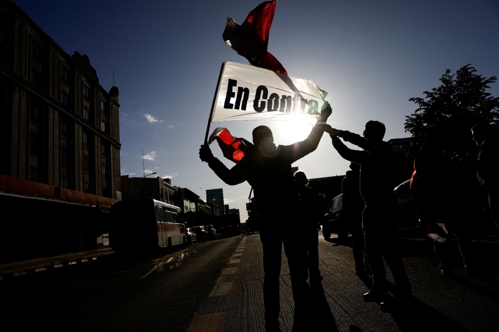 People against the new constitution react after polls closed, on the day of the referendum on a new Chilean constitution, in Concepcion, Chile, December 17, 2023. — Reuters pic  