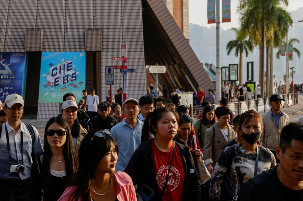 Tourists stroll through the streets of Tsim Sha Tsui, a bustling shopping hotspot, in Hong Kong December 5, 2023. — Reuters pic  