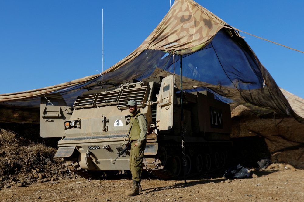 An Israeli soldier stands near a rocket launcher in the Israeli-occupied Golan Heights, November 6, 2023. — Reuters pic  