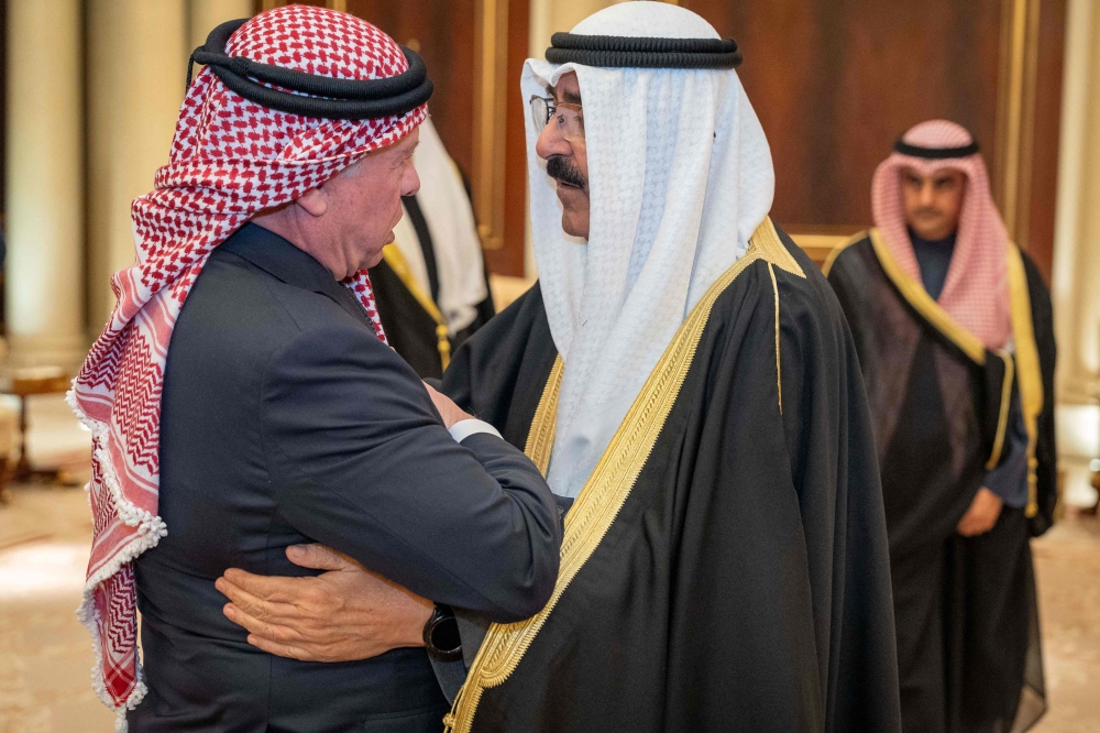 A handout picture released by the Jordanian Royal Palace shows Jordan's King Abdullah II (left) offering his condolences to Kuwait's new Emir Sheikh Meshal al-Ahmad al-Jaber al-Sabah after the passing of his predecessor and half-brother Sheikh Nawaf Al-Ahmad Al-Jaber Al-Sabah in Kuwait City December 17, 2023. —Chris Setian/Jordanian Royal Palace/AFP pic