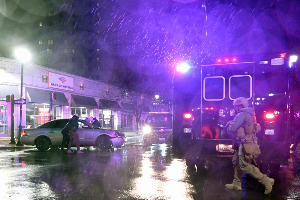 Members of the US Secret Service rush to a car, after it hit a motorcade SUV, as US president Joe Biden was leaving his campaign headquarters in Wilmington, Delaware December 17, 2023. — AFP pic